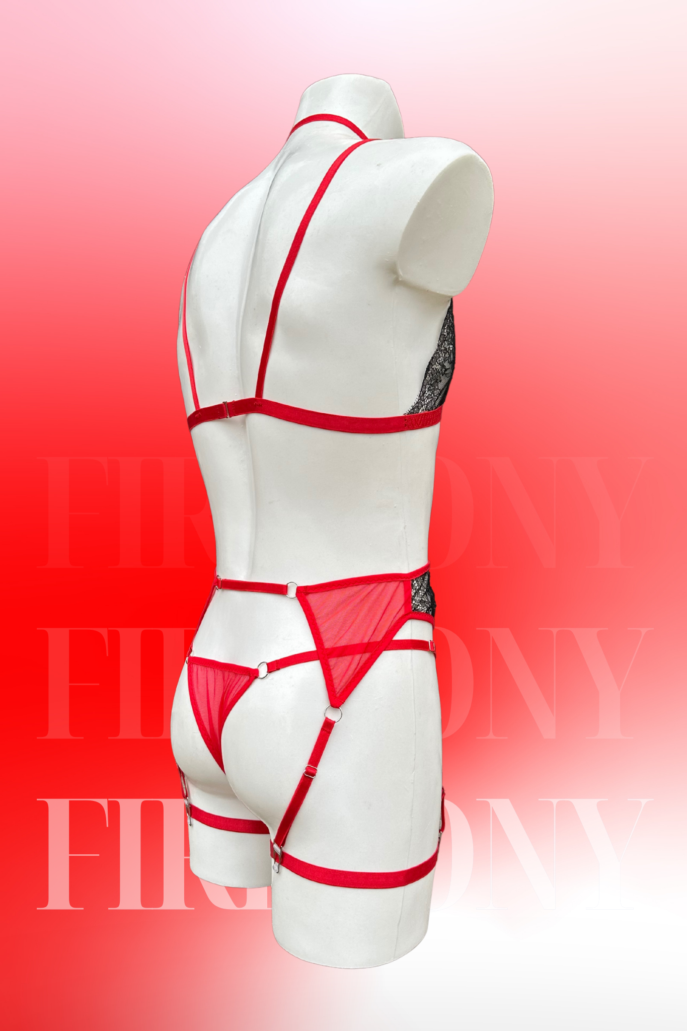 Angled back view focusing on the red mesh thong, garter belt, and strappy bra detail.