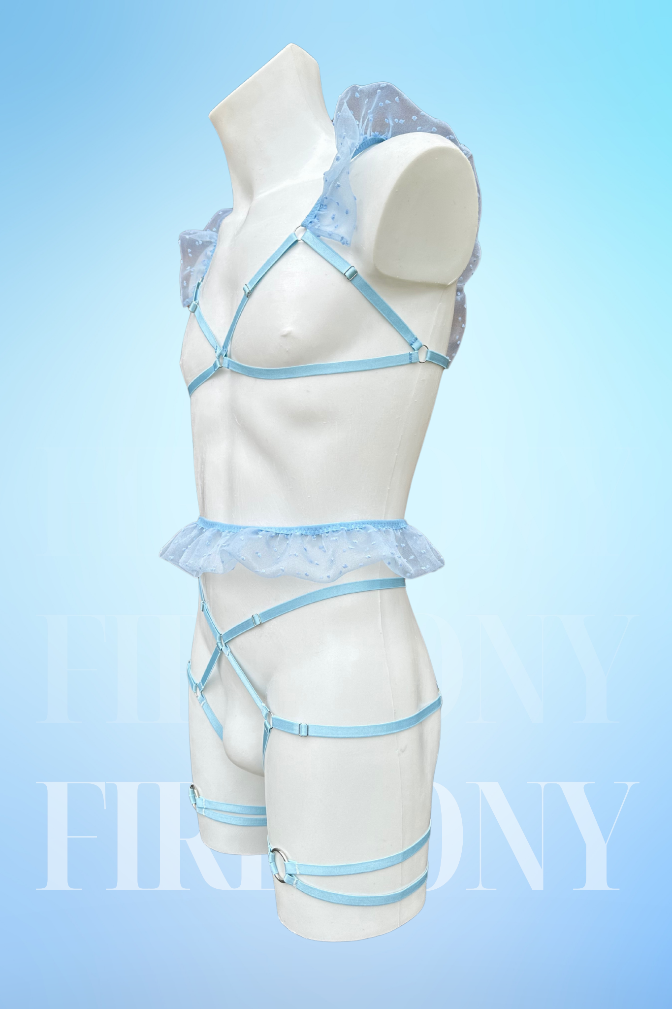 Side view of the same set showing sheer mesh ruffles on the shoulder and waist, with adjustable straps.