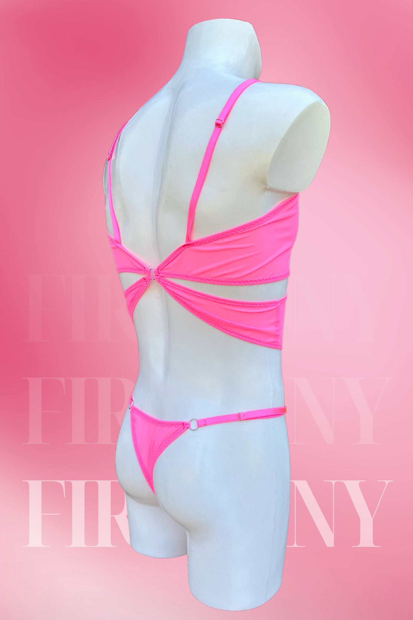 Side-back view of men’s pink mesh bodysuit with daring cut-outs and rings