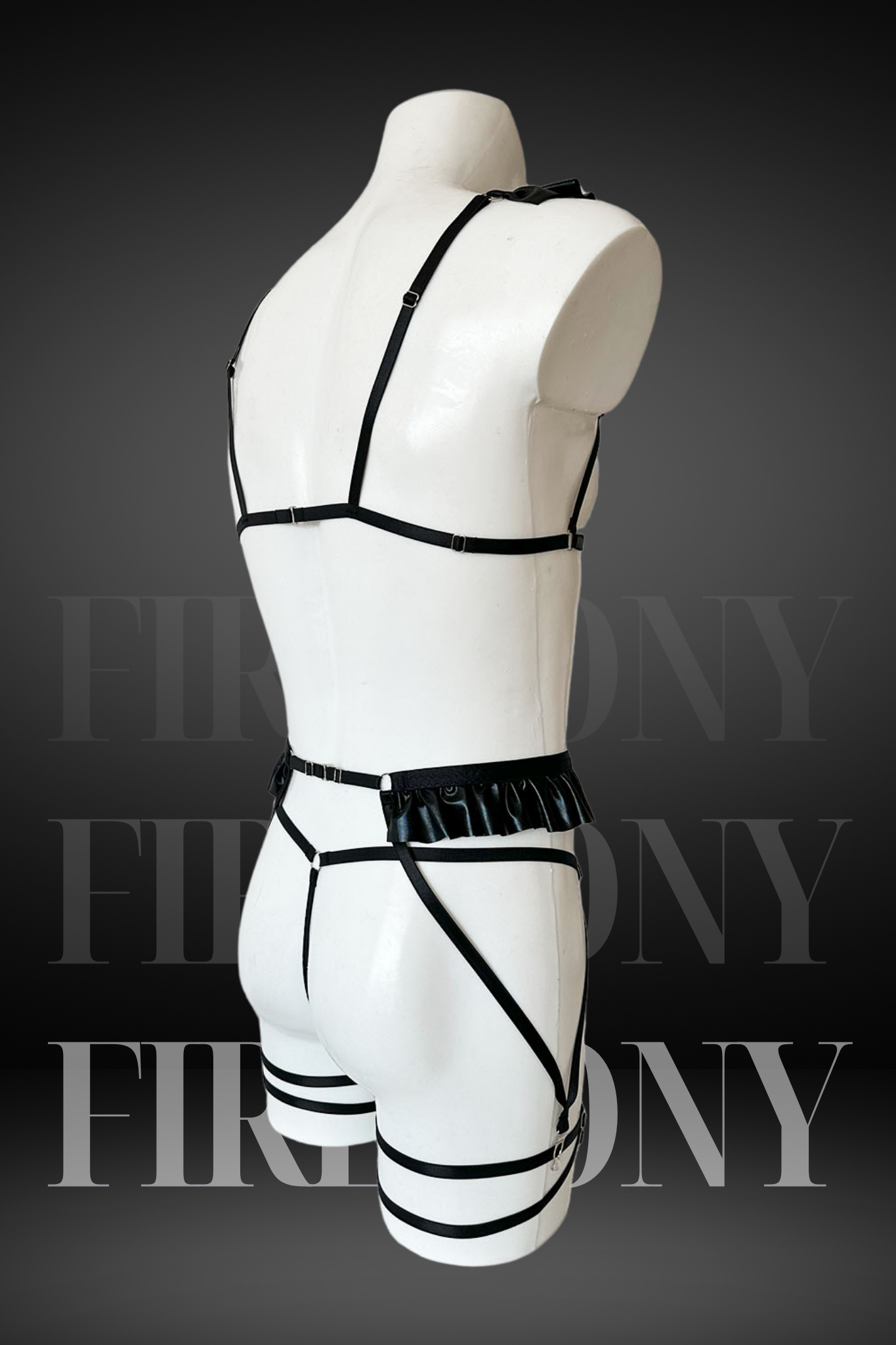 Close-up of ruffle and harness details on the men’s faux leather lingerie set