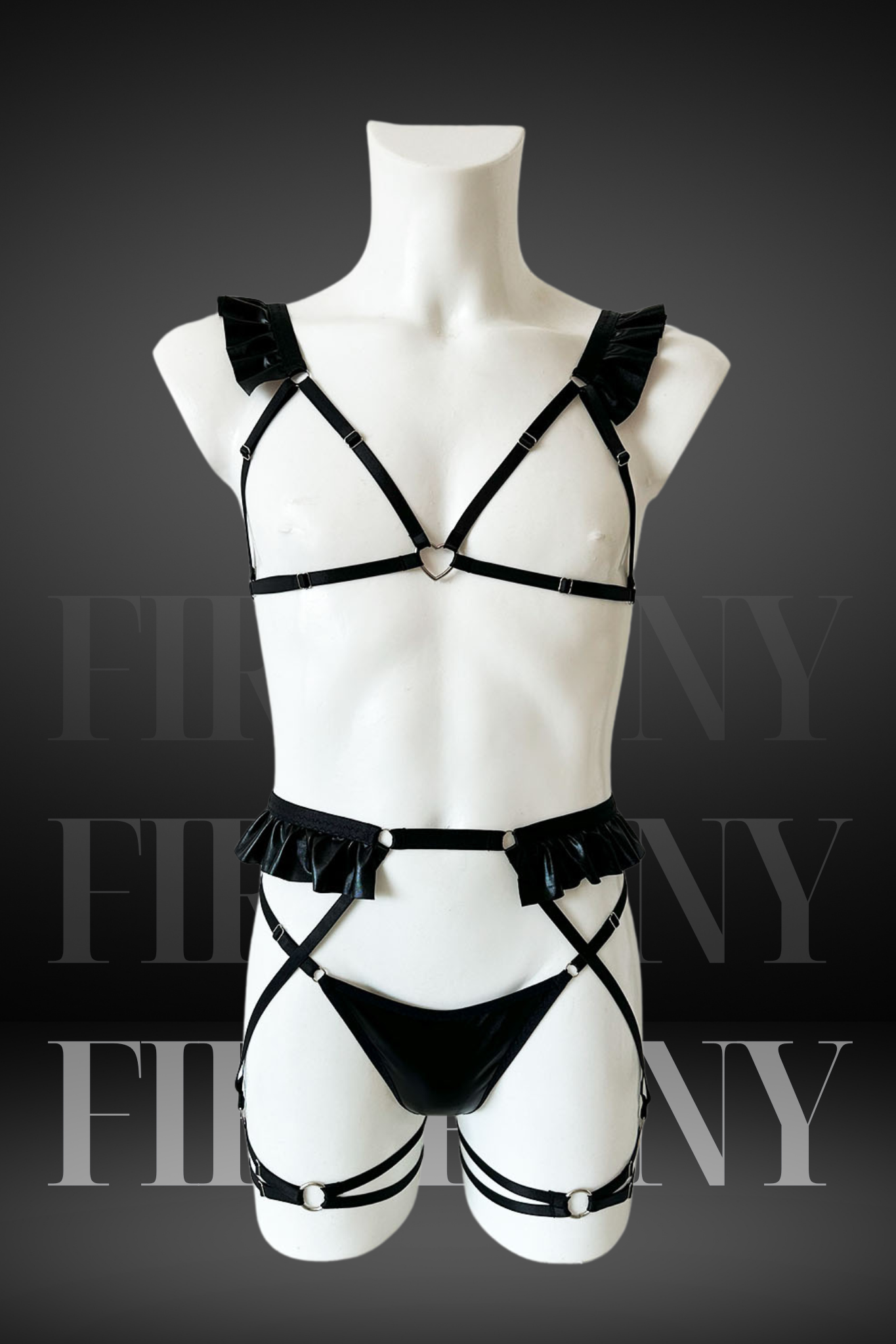 Black faux leather harness lingerie set for men with ruffle shoulder details and heart ring – front view