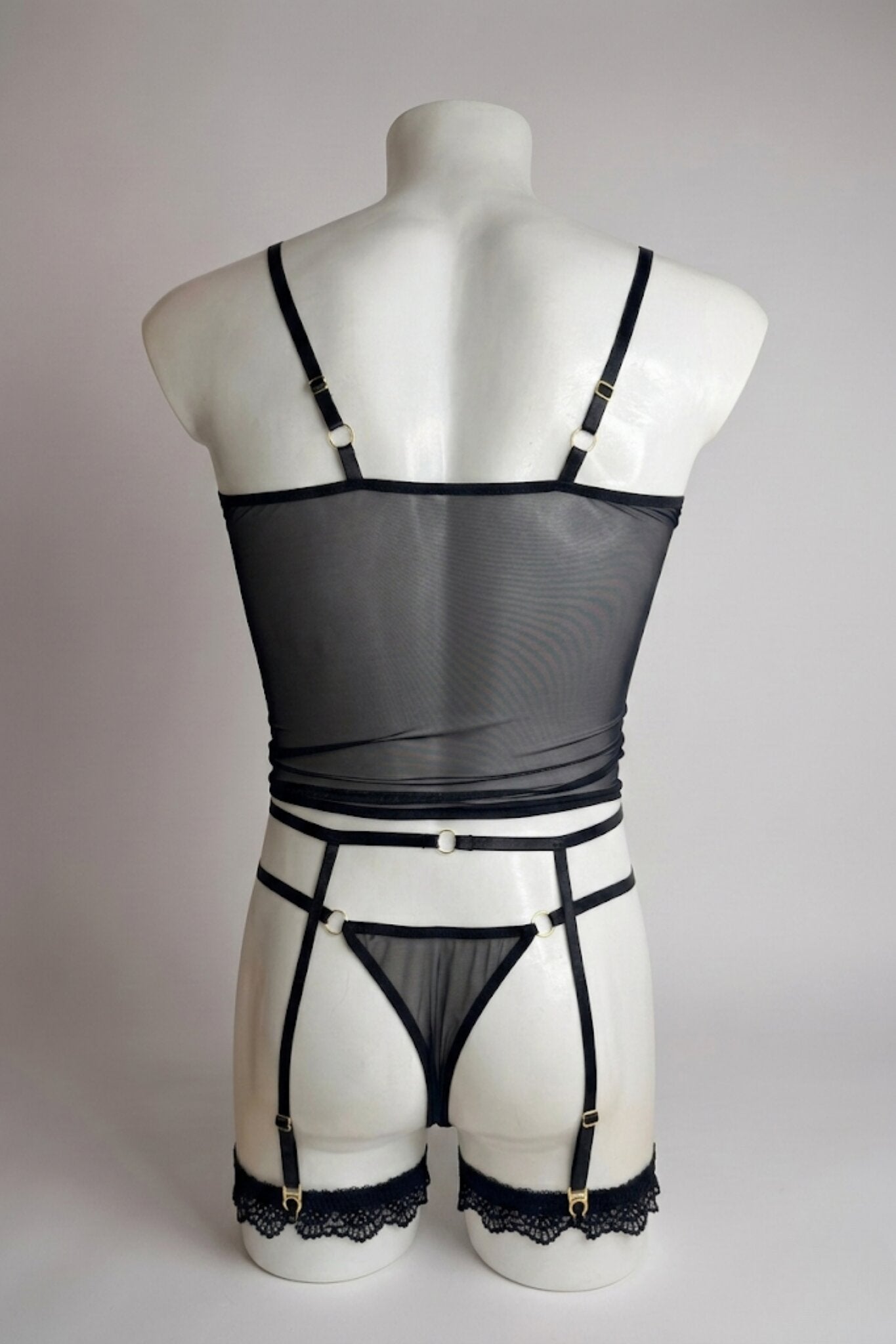 Back view of men's black mesh corset top set - sheer top, thong back and adjustable suspender straps