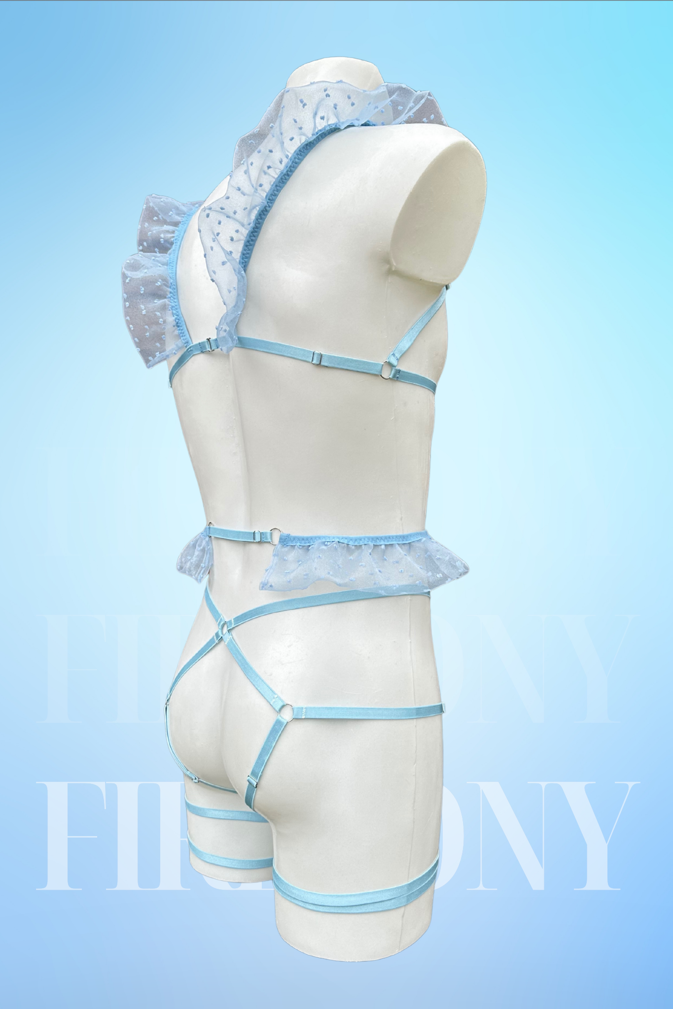 Angled back view focusing on the sheer ruffles, strappy harness, and leg garter straps