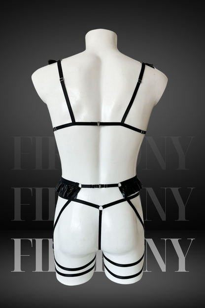 Back view of black strappy men’s harness lingerie with thong and garter straps

