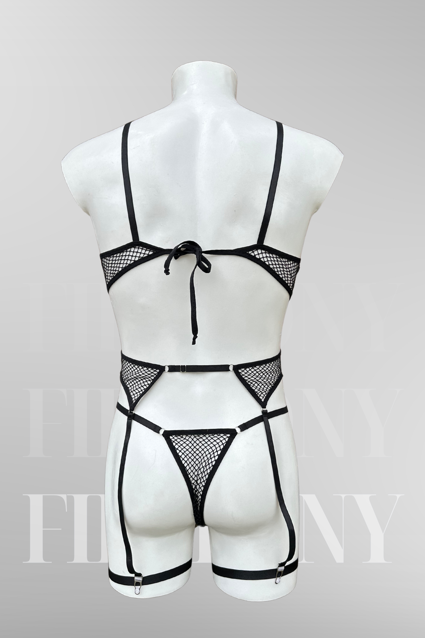  Front view of the black fishnet lingerie set highlighting the triangle bra, thong, and adjustable garters.