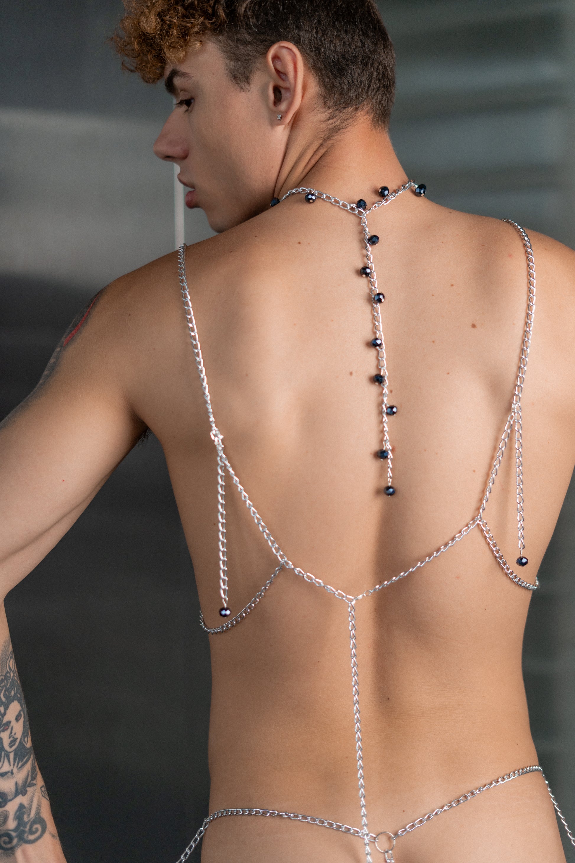 Close-up of vegan leather chain bra with crystal pearls