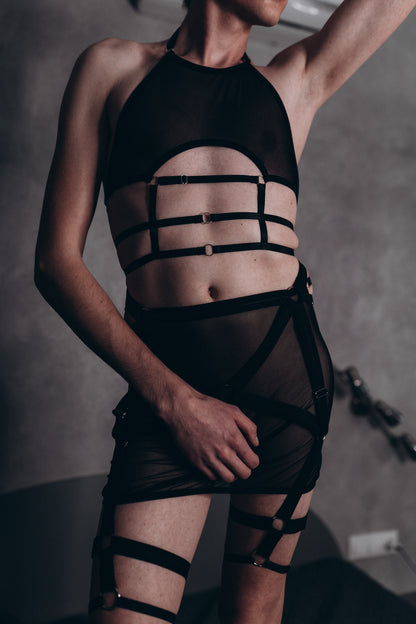 Black mesh skirt, bra, and leg harness set for men, designed for a daring, fetish-inspired look by Fireponyshop