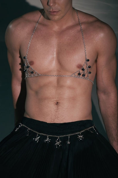 Man wearing Firepony silver chain body harness with black crystals in a dark studio setting.