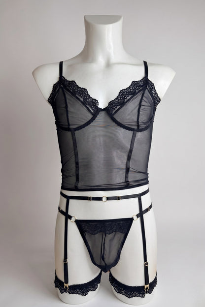 Black corset-style mesh top set for men on mannequin - lace trim top, thong and garter belt with gold hardware, front view