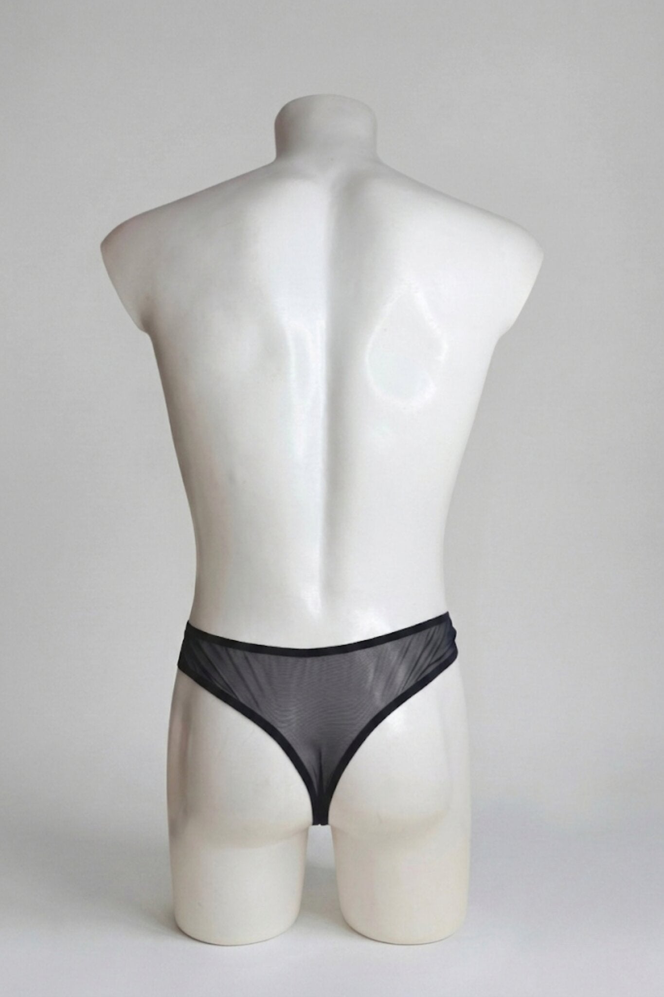 Back view of men's sheer black mesh thong - classic thong back with slim elastic waistband