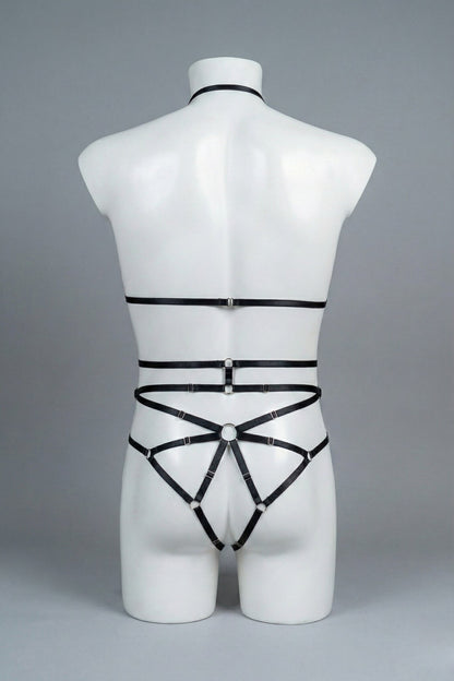 Back view of men's black strappy body harness set - crossing waist straps and open-frame back with o-rings
