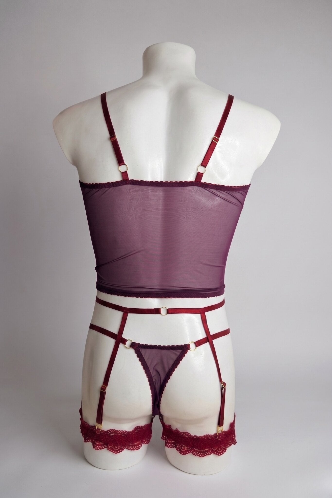 Back view of men's burgundy mesh corset top set - sheer plum top, thong back and adjustable suspender straps with gold rings