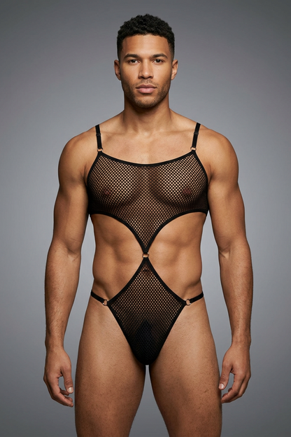 Man wearing a black fishnet bodysuit against a gray background