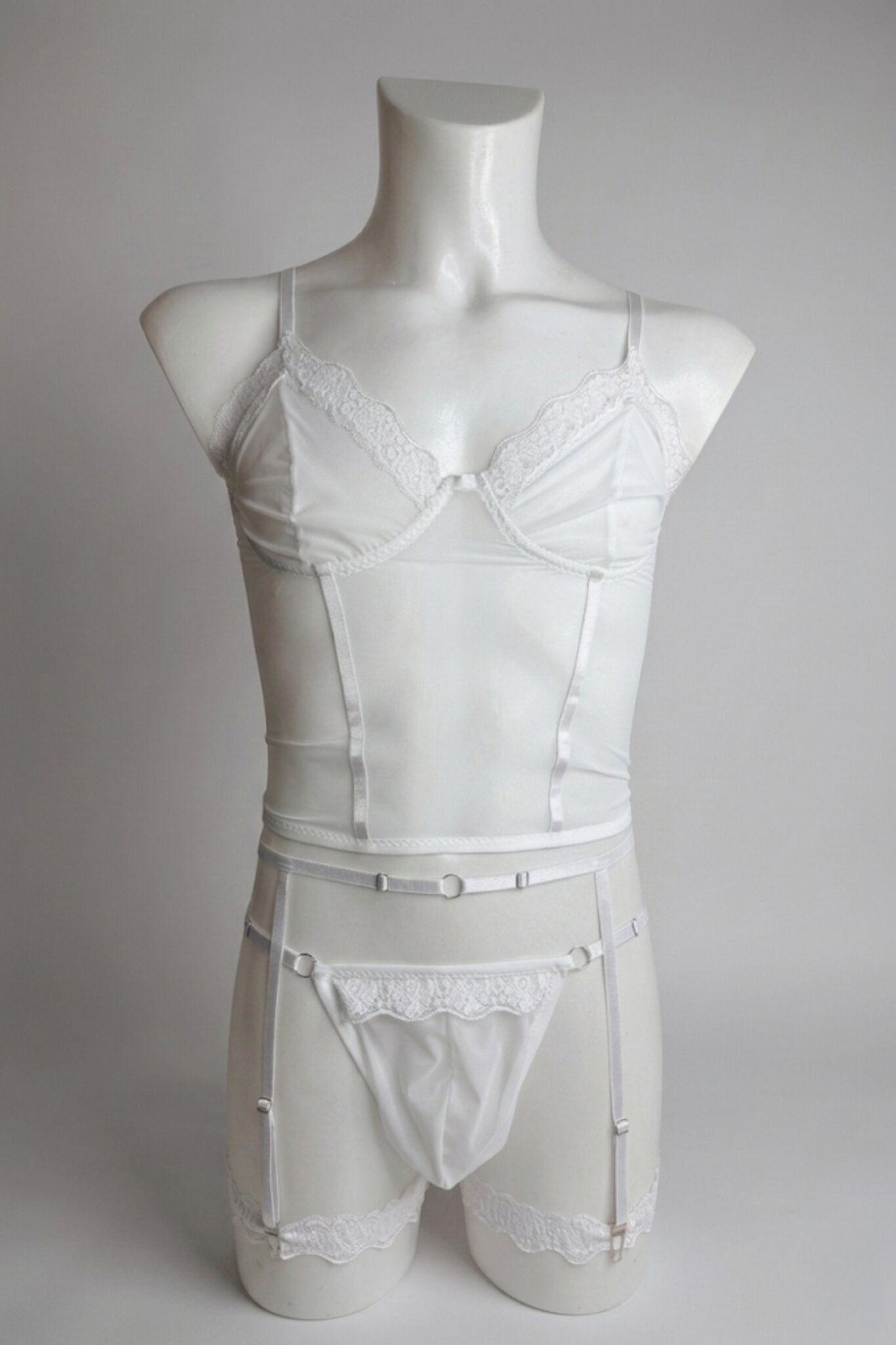 White corset-style mesh top set for men on mannequin - lace trim top, thong and garter belt, front view