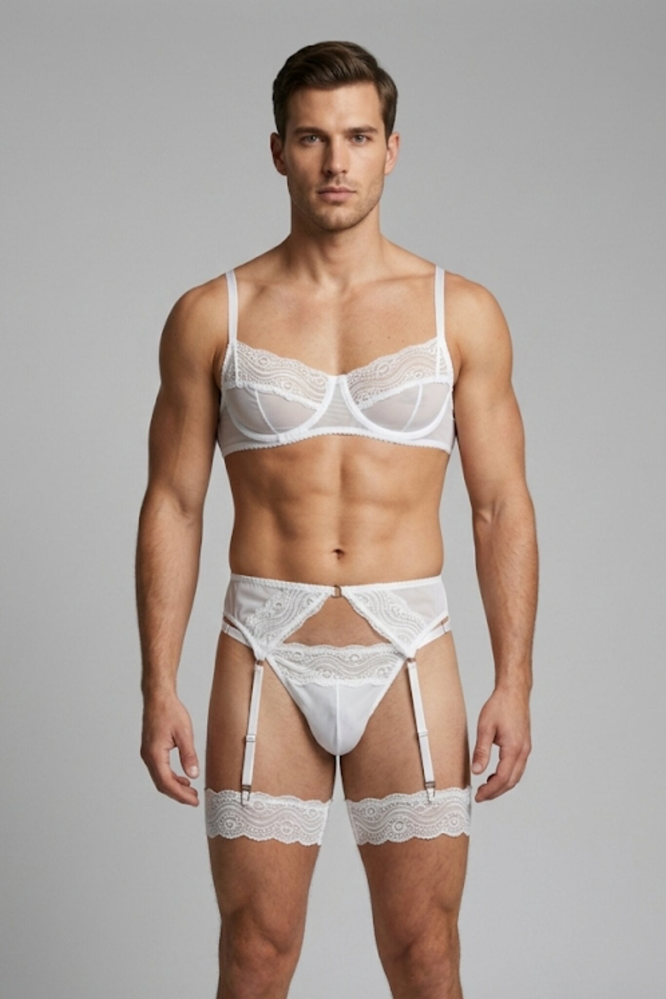 Man wearing white lace lingerie set for men - underwired bra, thong, garter belt and lace leg garters by Fire Pony