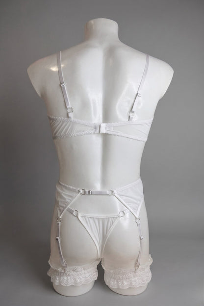 Back view of men's white lace lingerie set - bra hook closure, thong back and adjustable suspender straps