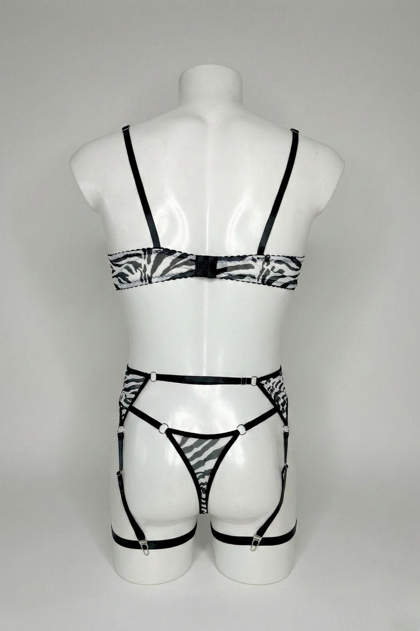 Back view of men's zebra mesh lingerie set - bra hook closure, thong back and adjustable suspender straps