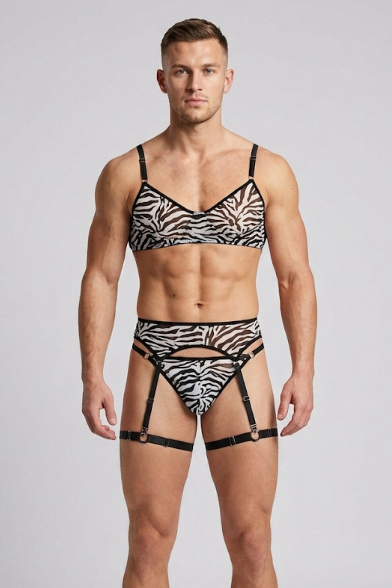Man wearing sheer zebra print mesh lingerie set for men - bra, thong, garter belt and leg garters by Fire Pony